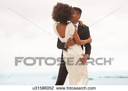 Stock Image - Couple hugging, Alto Vidigal, Rio de Janeiro, Brazil. Fotosearch