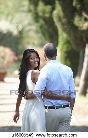Couple hugging and walking View Large Photo Image Stock Photo - Couple hugging and walking. Fotosearch