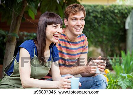 Stock Photography - Couple in garden laughing. Fotosearch