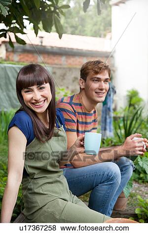 Couple in garden smiling View Large Photo Image Stock Photo - Couple in garden smiling. Fotosearch