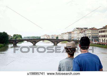 Couple looking at Ponte alle Grazie, Florence, Tuscany, Italy View Large Photo Image Stock Image - Couple looking at Ponte alle Grazie, Florence, Tuscany, Italy. Fotosearch