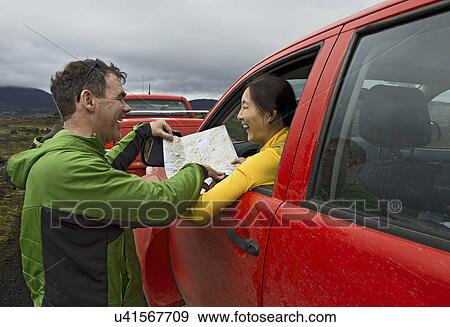 Couple reading map by customised SUV, Fjallabak, Iceland View Large Photo Image Stock Photo - Couple reading map by customised SUV, Fjallabak, Iceland. Fotosearch