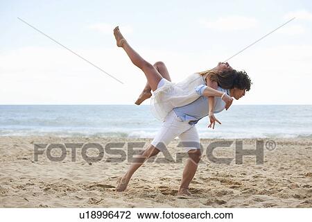 Stock Image - Couple tangoing on beach. Fotosearch
