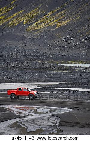 Stock Image - Customised SUV on sandy river bed close to Eyjafjallajokull, Thorsmork, Iceland. Fotosearch