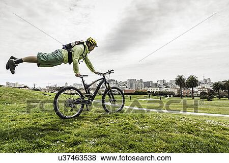 Cyclist balancing body on bike View Large Photo Image Stock Photo - Cyclist balancing body on bike. Fotosearch