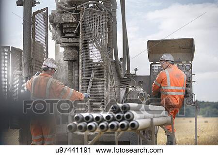 Drilling rig workers operating machinery View Large Photo Image Stock Image - Drilling rig workers operating machinery. Fotosearch