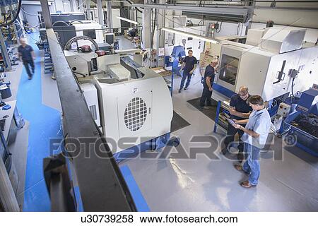Elevated view of workers in engineering plant View Large Photo Image Stock Photo - Elevated view of workers in engineering plant. Fotosearch