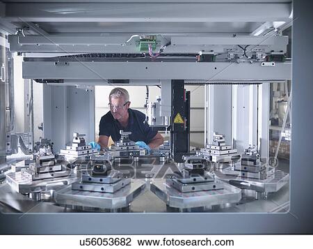 Engineer inspecting automatic lathe in factory View Large Photo Image Stock Image - Engineer inspecting automatic lathe in factory. Fotosearch