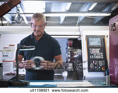 Engineer inspecting metal part in factory View Large Photo Image Stock Image - Engineer inspecting metal part in factory. Fotosearch