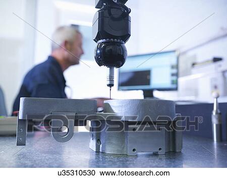 Engineer measuring components in factory View Large Photo Image Stock Image - Engineer measuring components in factory. Fotosearch