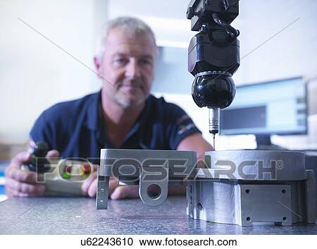 Engineer measuring components in factory View Large Photo Image Stock Image - Engineer measuring components in factory. Fotosearch
