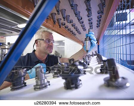 Engineer selecting lathe cutting tools in factory View Large Photo Image Picture - Engineer selecting lathe cutting tools in factory. Fotosearch