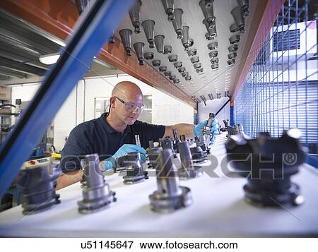 Engineer selecting lathe cutting tools in factory View Large Photo Image Stock Photo - Engineer selecting lathe cutting tools in factory. Fotosearch
