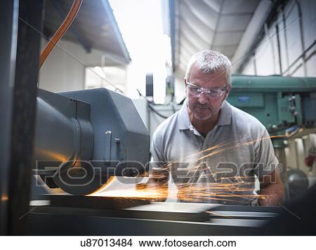 Engineer using grinder in factory View Large Photo Image Picture - Engineer using grinder in factory. Fotosearch