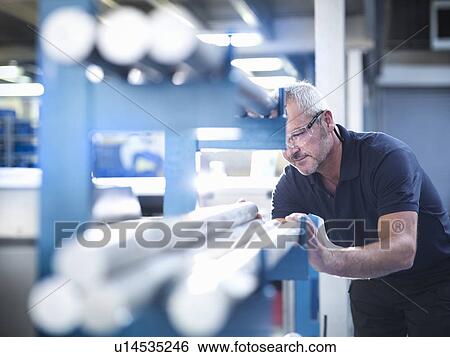 Stock Photograph - Engineer working with aluminium in factory. Fotosearch
