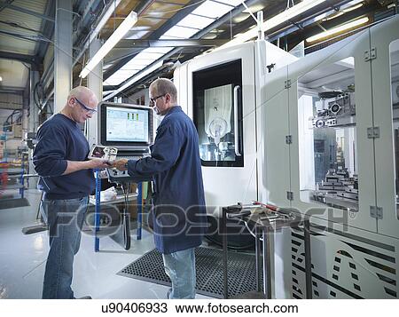 Engineers inspecting part at computer numerical controlled lathe (CNC) in factory View Large Photo Image Stock Image - Engineers inspecting part at computer numerical controlled lathe (CNC) in factory. Fotosearch