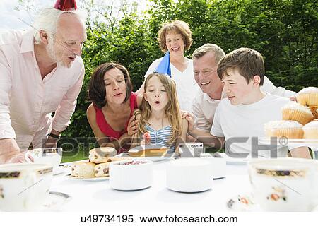 Family celebrating girl's birthday View Large Photo Image Stock Photography - Family celebrating girl's birthday. Fotosearch