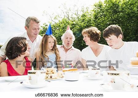 Stock Photograph - Family celebrating grandfather's birthday. Fotosearch