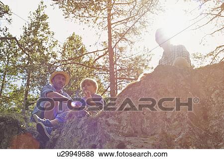 Family having picnic sitting on rocks View Large Photo Image Stock Photo - Family having picnic sitting on rocks. Fotosearch