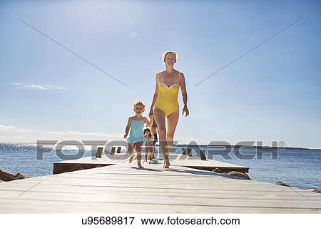 Family walking on jetty, Utvalnas, Gavle, Sweden View Large Photo Image Stock Photo - Family walking on jetty, Utvalnas, Gavle, Sweden. Fotosearch