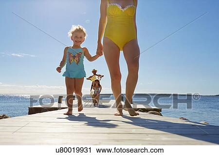 Stock Image - Family walking on pier, Utvalnas, Gavle, Sweden. Fotosearch