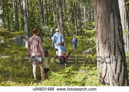Stock Photo - Family walking through forest. Fotosearch