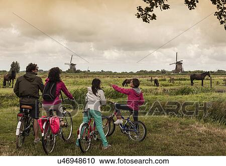 Stock Image - Family with two children on bikes, Kinderdijk, Olanda, Amsterdam. Fotosearch