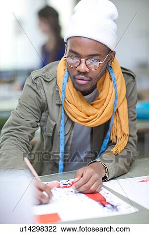 Stock Image - Fashion design student in class. Fotosearch