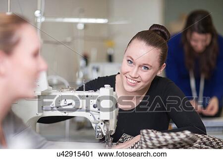 Stock Image - Fashion design students in class. Fotosearch