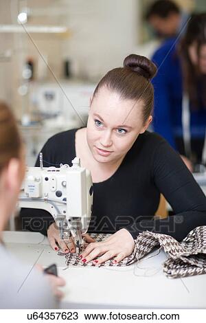 Stock Image - Fashion design students in class. Fotosearch