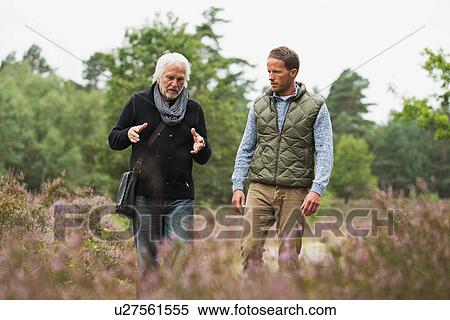Father and adult son walking View Large Photo Image Stock Photography - Father and adult son walking. Fotosearch