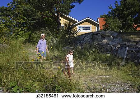 Stock Image - Father and daughter strolling, Utvalnas, Gavle, Sweden. Fotosearch