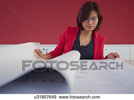 Female architect with blueprints View Large Photo Image Stock Photo - Female architect with blueprints. Fotosearch