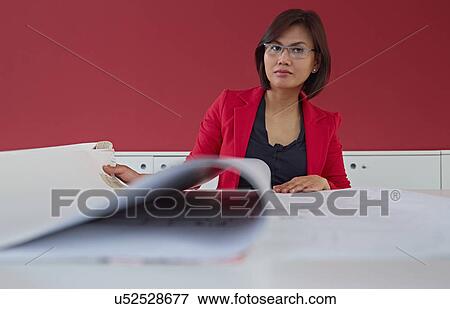 Stock Photo - Female architect with blueprints. Fotosearch