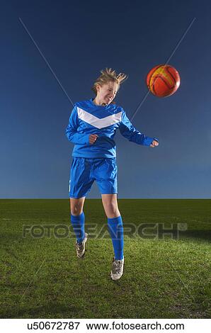 Female footballer heading the ball View Large Photo Image Stock Photo - Female footballer heading the ball. Fotosearch