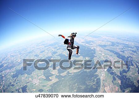Female skydiver free falling above Leutkirch, Bavaria, Germany View Large Photo Image Stock Image - Female skydiver free falling above Leutkirch, Bavaria, Germany. Fotosearch