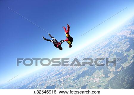 Stock Photograph - Female skydivers upside down above Leutkirch, Bavaria, Germany. Fotosearch