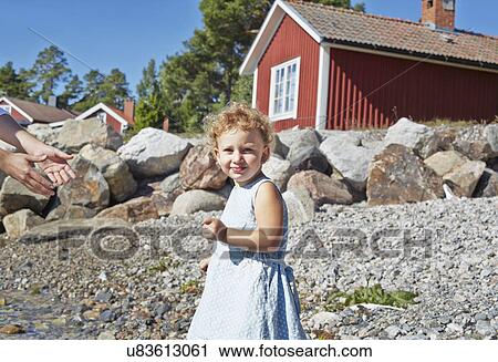 Female toddler and father on beach, Utvalnas, Gavle, Sweden View Large Photo Image Stock Image - Female toddler and father on beach, Utvalnas, Gavle, Sweden. Fotosearch