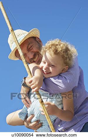 Picture - Female toddler and father with fishing net, Utvalnas, Gavle, Sweden. Fotosearch