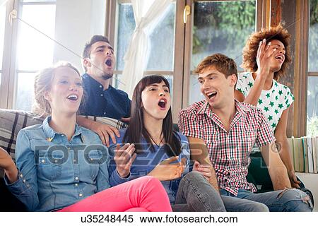 Stock Photography - Five friends watching television. Fotosearch