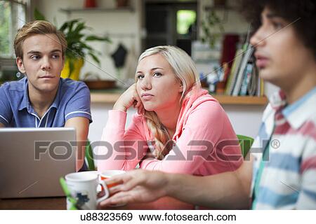 Flatmates sitting around kitchen table View Large Photo Image Stock Photo - Flatmates sitting around kitchen table. Fotosearch