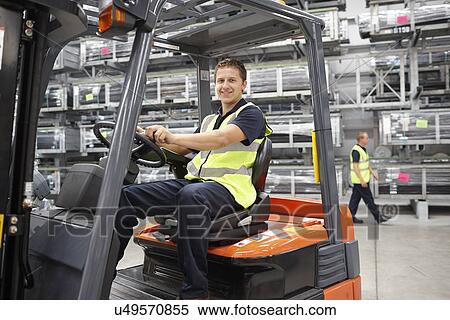 Forklift truck driver in engineering warehouse View Large Photo Image Stock Photography - Forklift truck driver in engineering warehouse. Fotosearch