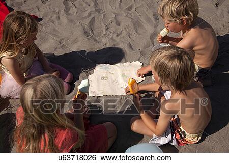 Four friends eating ice creams on beach, high angle, Wales, UK View Large Photo Image Stock Photograph - Four friends eating ice creams on beach, high angle, Wales, UK. Fotosearch