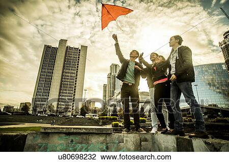 Four friends flying kite, Russia View Large Photo Image Stock Image - Four friends flying kite, Russia. Fotosearch