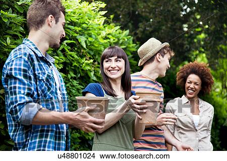 Four friends holding terracotta plant pots View Large Photo Image Picture - Four friends holding terracotta plant pots. Fotosearch