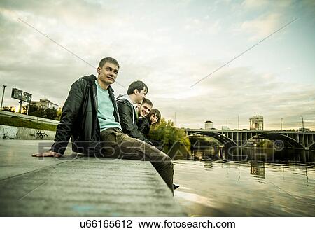 Four friends sitting by river, Russia View Large Photo Image Stock Image - Four friends sitting by river, Russia. Fotosearch