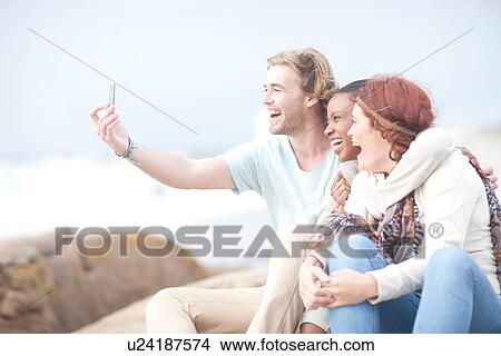 Friends having fun on beach View Large Photo Image Picture - Friends having fun on beach. Fotosearch