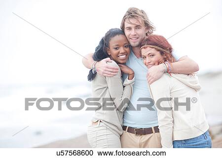 Stock Image - Friends having fun on beach. Fotosearch