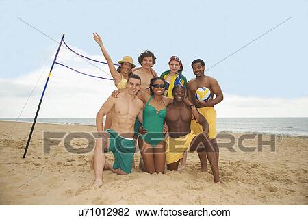 Friends posing for camera on beach View Large Photo Image Stock Image - Friends posing for camera on beach. Fotosearch