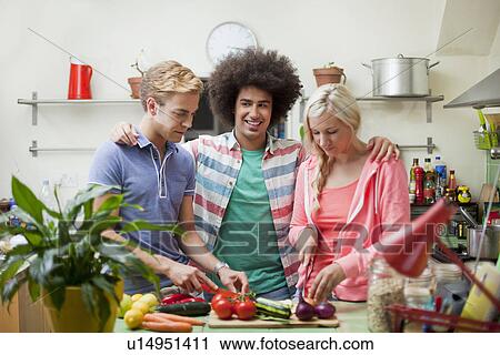 Friends preparing vegetables in kitchen View Large Photo Image Stock Image - Friends preparing vegetables in kitchen. Fotosearch